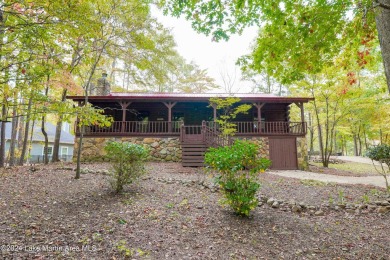 This 3 bedroom, 2 bath one level log home sits on a large flat on Stillwaters Golf and Country Club in Alabama - for sale on GolfHomes.com, golf home, golf lot