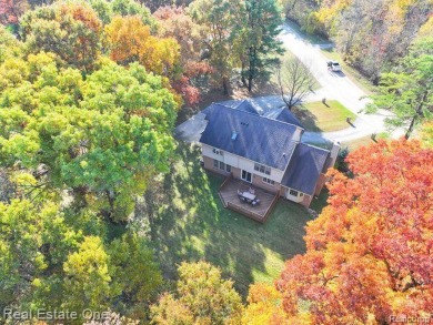 THIS IS THE WHOLE PACKAGE! Situated on nearly 2 acres with a on Paint Creek Country Club in Michigan - for sale on GolfHomes.com, golf home, golf lot
