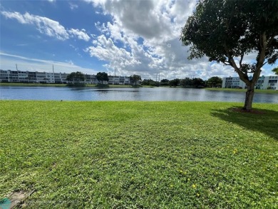 WATERVIEW! FIRST FLOOR, TWO BEDROOM, TWO FULL BATH HOME WITH A on Hillsboro Pines Golf in Florida - for sale on GolfHomes.com, golf home, golf lot