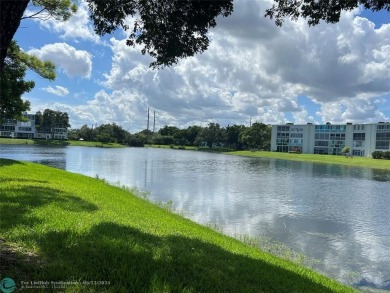 WATERVIEW! FIRST FLOOR, TWO BEDROOM, TWO FULL BATH HOME WITH A on Hillsboro Pines Golf in Florida - for sale on GolfHomes.com, golf home, golf lot