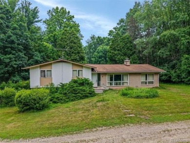 Step into this one-of-a-kind mid-century modern home tucked away on Kensington Metropark Golf Course in Michigan - for sale on GolfHomes.com, golf home, golf lot