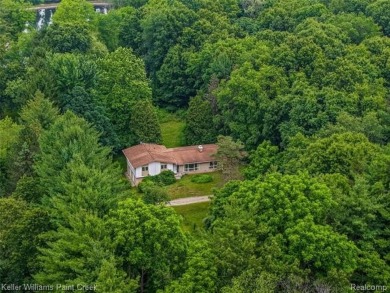 Step into this one-of-a-kind mid-century modern home tucked away on Kensington Metropark Golf Course in Michigan - for sale on GolfHomes.com, golf home, golf lot