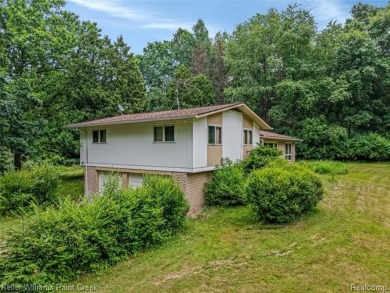 Step into this one-of-a-kind mid-century modern home tucked away on Kensington Metropark Golf Course in Michigan - for sale on GolfHomes.com, golf home, golf lot