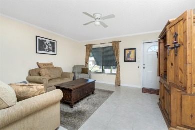 Absolutely Charming home nestled on a large fenced yard along a on Port Charlotte Golf Club in Florida - for sale on GolfHomes.com, golf home, golf lot