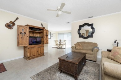 Absolutely Charming home nestled on a large fenced yard along a on Port Charlotte Golf Club in Florida - for sale on GolfHomes.com, golf home, golf lot