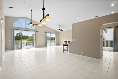 Soak in serene lake views with a backdrop of the golf course in on Santa Lucia River Club in Florida - for sale on GolfHomes.com, golf home, golf lot