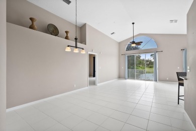 Soak in serene lake views with a backdrop of the golf course in on Santa Lucia River Club in Florida - for sale on GolfHomes.com, golf home, golf lot