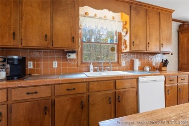 Say *Welcome Home* to this adorable English cottage-style home on Carolina Trace Country Club in North Carolina - for sale on GolfHomes.com, golf home, golf lot