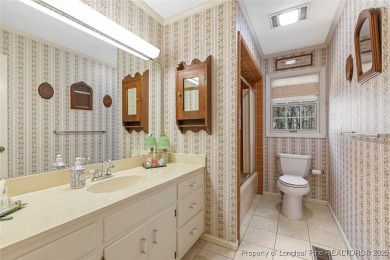 Say *Welcome Home* to this adorable English cottage-style home on Carolina Trace Country Club in North Carolina - for sale on GolfHomes.com, golf home, golf lot