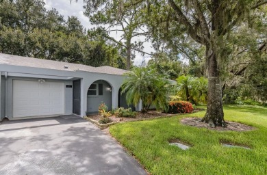 Tucked beneath the shade of moss-draped oaks and overlooking on Tarpon Woods Golf Club in Florida - for sale on GolfHomes.com, golf home, golf lot
