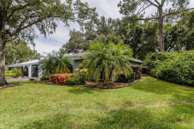 Tucked beneath the shade of moss-draped oaks and overlooking on Tarpon Woods Golf Club in Florida - for sale on GolfHomes.com, golf home, golf lot