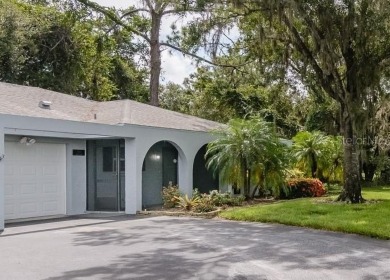 Tucked beneath the shade of moss-draped oaks and overlooking on Tarpon Woods Golf Club in Florida - for sale on GolfHomes.com, golf home, golf lot