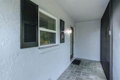 Tucked beneath the shade of moss-draped oaks and overlooking on Tarpon Woods Golf Club in Florida - for sale on GolfHomes.com, golf home, golf lot
