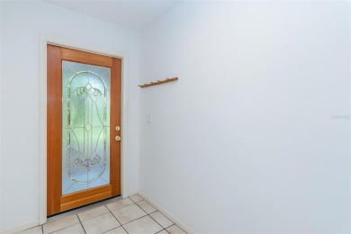 Tucked beneath the shade of moss-draped oaks and overlooking on Tarpon Woods Golf Club in Florida - for sale on GolfHomes.com, golf home, golf lot
