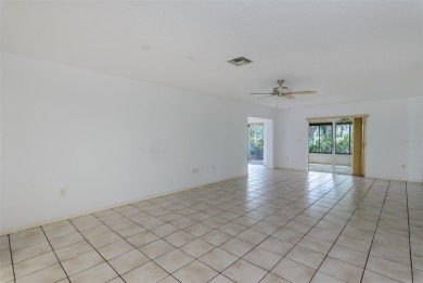 Tucked beneath the shade of moss-draped oaks and overlooking on Tarpon Woods Golf Club in Florida - for sale on GolfHomes.com, golf home, golf lot