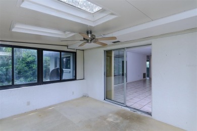 Tucked beneath the shade of moss-draped oaks and overlooking on Tarpon Woods Golf Club in Florida - for sale on GolfHomes.com, golf home, golf lot