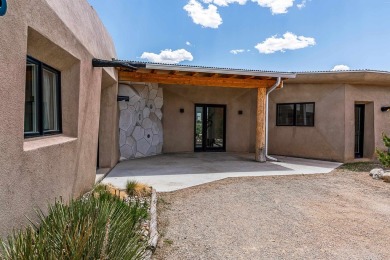 Live inside a work of art in this  Artist's Dream Dwelling in on Taos Country Club in New Mexico - for sale on GolfHomes.com, golf home, golf lot