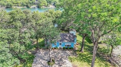 This quaint and charming LAKEFRONT bungalow offers a peaceful on Linn Valley Lakes - Deer Trace Golf Course in Kansas - for sale on GolfHomes.com, golf home, golf lot