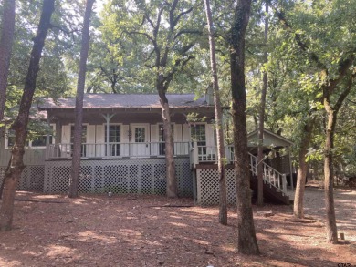 This one-owner home sits on three wooded lots for a total of .75 on Holly Lake Ranch Golf Club in Texas - for sale on GolfHomes.com, golf home, golf lot
