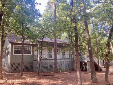 This one-owner home sits on three wooded lots for a total of .75 on Holly Lake Ranch Golf Club in Texas - for sale on GolfHomes.com, golf home, golf lot