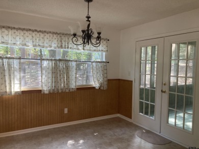 This one-owner home sits on three wooded lots for a total of .75 on Holly Lake Ranch Golf Club in Texas - for sale on GolfHomes.com, golf home, golf lot