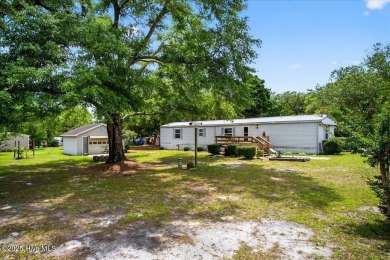 This  two bedroom, two bath home located in the sought after on Oyster Bay Golf Links in North Carolina - for sale on GolfHomes.com, golf home, golf lot