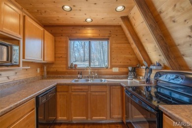 Private setting on lake Silveratta,  newer style custom chalet on Innsbrook Resort Golf Course in Missouri - for sale on GolfHomes.com, golf home, golf lot