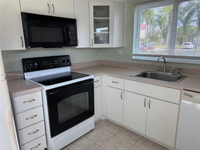 Discover the potential of this spacious 2 BR, 2 BTH corner condo on Sunrise Lakes Phase III in Florida - for sale on GolfHomes.com, golf home, golf lot