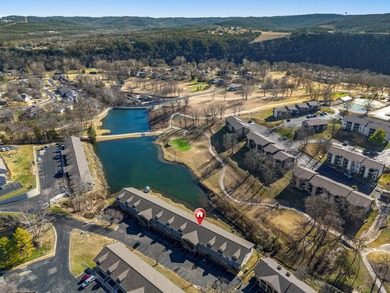 Wake up to the gentle shimmer of Lake Taneycomo right outside on Pointe Royale Village Country Club in Missouri - for sale on GolfHomes.com, golf home, golf lot