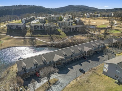 Wake up to the gentle shimmer of Lake Taneycomo right outside on Pointe Royale Village Country Club in Missouri - for sale on GolfHomes.com, golf home, golf lot