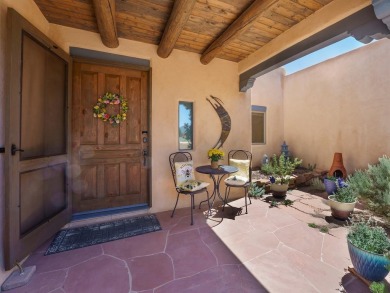 This exceptional adobe-style home, with a stucco exterior and on Taos Country Club in New Mexico - for sale on GolfHomes.com, golf home, golf lot