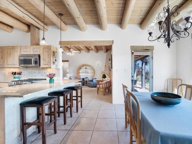 This exceptional adobe-style home, with a stucco exterior and on Taos Country Club in New Mexico - for sale on GolfHomes.com, golf home, golf lot