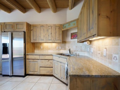 This exceptional adobe-style home, with a stucco exterior and on Taos Country Club in New Mexico - for sale on GolfHomes.com, golf home, golf lot