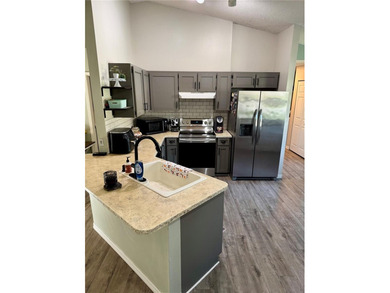 Check out this beautifully maintained home nestled in the on The Grand Club - Pine Lakes Course in Florida - for sale on GolfHomes.com, golf home, golf lot