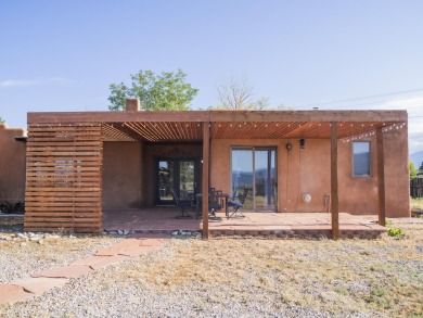 Discover unparalleled beauty and comfort in this exquisite on Taos Country Club in New Mexico - for sale on GolfHomes.com, golf home, golf lot