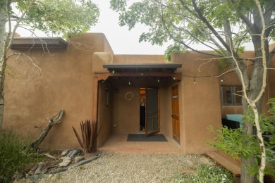 Discover unparalleled beauty and comfort in this exquisite on Taos Country Club in New Mexico - for sale on GolfHomes.com, golf home, golf lot