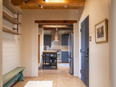 Discover unparalleled beauty and comfort in this exquisite on Taos Country Club in New Mexico - for sale on GolfHomes.com, golf home, golf lot