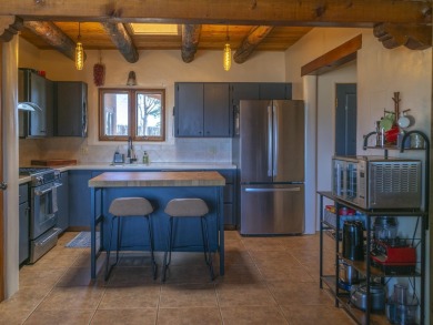 Discover unparalleled beauty and comfort in this exquisite on Taos Country Club in New Mexico - for sale on GolfHomes.com, golf home, golf lot