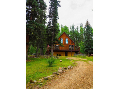 Discover this updated cabin retreat steps from golfing, fishing on El Valle Escondido Golf Course in New Mexico - for sale on GolfHomes.com, golf home, golf lot