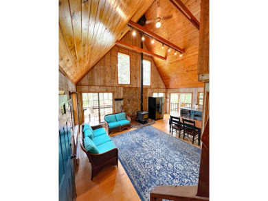 Discover this updated cabin retreat steps from golfing, fishing on El Valle Escondido Golf Course in New Mexico - for sale on GolfHomes.com, golf home, golf lot