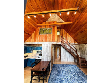 Discover this updated cabin retreat steps from golfing, fishing on El Valle Escondido Golf Course in New Mexico - for sale on GolfHomes.com, golf home, golf lot