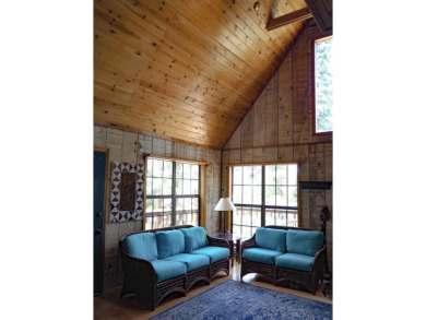 Discover this updated cabin retreat steps from golfing, fishing on El Valle Escondido Golf Course in New Mexico - for sale on GolfHomes.com, golf home, golf lot