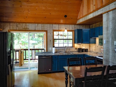 Discover this updated cabin retreat steps from golfing, fishing on El Valle Escondido Golf Course in New Mexico - for sale on GolfHomes.com, golf home, golf lot