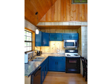 Discover this updated cabin retreat steps from golfing, fishing on El Valle Escondido Golf Course in New Mexico - for sale on GolfHomes.com, golf home, golf lot