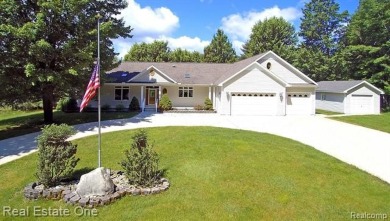 Step inside and discover a thoughtfully designed split ranch on Lost Lake Woods Club in Michigan - for sale on GolfHomes.com, golf home, golf lot