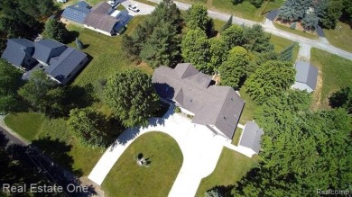 Step inside and discover a thoughtfully designed split ranch on Lost Lake Woods Club in Michigan - for sale on GolfHomes.com, golf home, golf lot