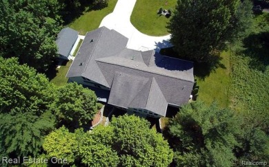 Step inside and discover a thoughtfully designed split ranch on Lost Lake Woods Club in Michigan - for sale on GolfHomes.com, golf home, golf lot