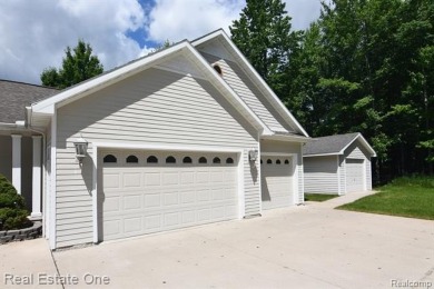 Step inside and discover a thoughtfully designed split ranch on Lost Lake Woods Club in Michigan - for sale on GolfHomes.com, golf home, golf lot