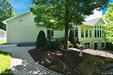 Step inside and discover a thoughtfully designed split ranch on Lost Lake Woods Club in Michigan - for sale on GolfHomes.com, golf home, golf lot