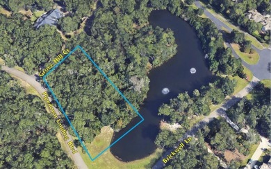 This exceptional private, wooded corner lot offers a on Willbrook Plantation in South Carolina - for sale on GolfHomes.com, golf home, golf lot